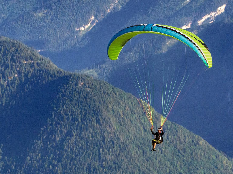 Tandem paragliding over Khajjiar meadows with Himalayan backdrop