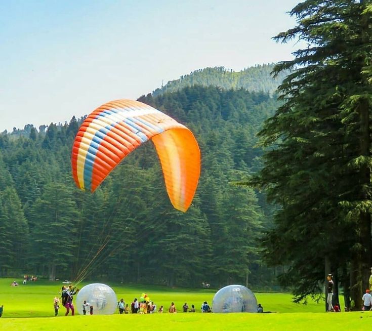 Group of happy paragliding customers at Khajjiar landing site
